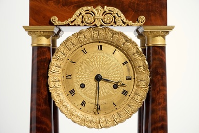 An Empire mahogany and gilt bronze portico mantle clock, France, 19th C.