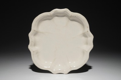 A polychrome Dutch Delft &quot;Four-hearts&quot; plate and a quatrefoil white Delft plate, 18th C.