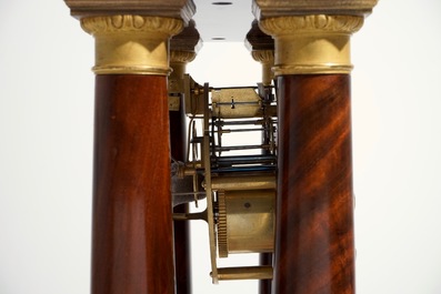 An Empire mahogany and gilt bronze portico mantle clock, France, 19th C.