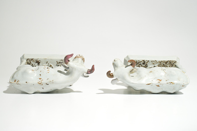 A pair of large cold-painted white Dutch Delft cows on bases, 18th C.