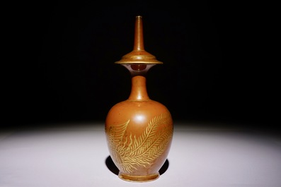 A Chinese monochrome persimmon-glazed kundika with applied gilt decoration, 18/19th C.