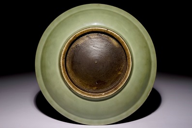 A Chinese celadon dish with incised lotus design, 18/19th C.