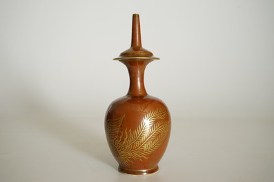 A Chinese monochrome persimmon-glazed kundika with applied gilt decoration, 18/19th C.