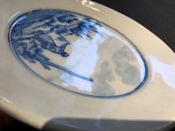 A Dutch Delft blue and white armorial dish dated 1683 and a blue and white landscape plate, 17th C.