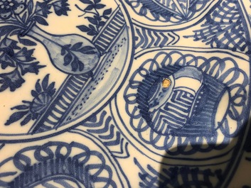A Dutch Delft blue and white chinoiserie dish with a flower vase in Wanli style, 2nd half 17th C.