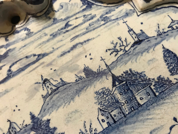 A Dutch Delft blue and white plaque with a lady in a landscape, 18th C.