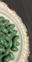 Une assiette trompe l'oeil aux olives en fa&iuml;ence de Moustiers, 18&egrave;me
