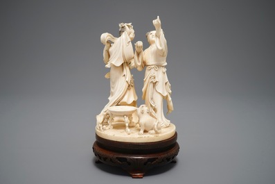 A Chinese carved ivory group of two ladies near an altar table, 1st half 20th C.