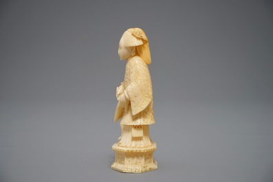 A Chinese pierced ivory basket and a small group of a lady with child, 19th C.