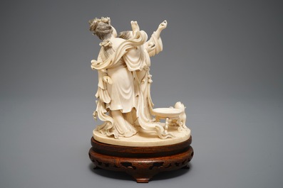 A Chinese carved ivory group of two ladies near an altar table, 1st half 20th C.