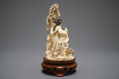 A Chinese carved ivory group of two ladies on inlaid wooden base, 1st half 20th C.