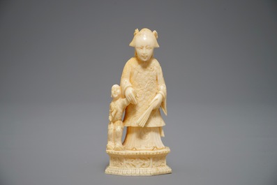 A Chinese pierced ivory basket and a small group of a lady with child, 19th C.