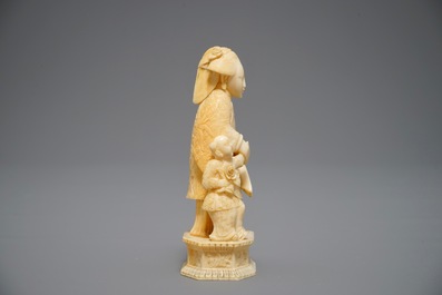A Chinese pierced ivory basket and a small group of a lady with child, 19th C.