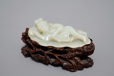 A Chinese celadon jade model of a reclining lady on lotus leaf, Qing