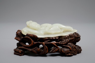 A Chinese celadon jade model of a reclining lady on lotus leaf, Qing