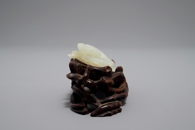 A Chinese celadon jade model of a reclining lady on lotus leaf, Qing
