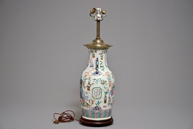 Een Chinese famille rose vaas met reli&euml;fdecor als lamp gemonteerd, 19e eeuw