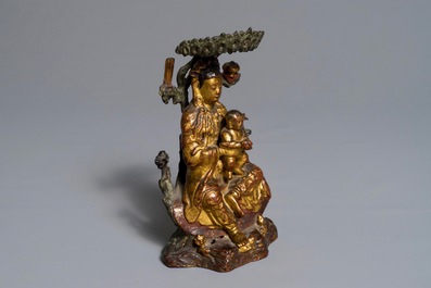 A Chinese gilt-lacquered bronze group of Guanyin with a child, 18th C.