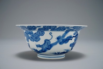 A Chinese blue and white klapmuts bowl with a tiger fighting a dragon, Chenghua mark, Kangxi