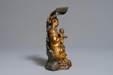 A Chinese gilt-lacquered bronze group of Guanyin with a child, 18th C.