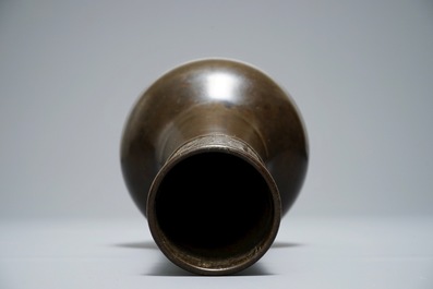 A Chinese bottle-shaped bronze vase with applied design, Yuan