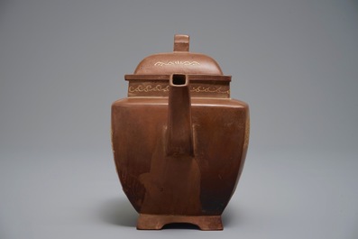 A Chinese Yixing teapot and cover with applied design, 20th C.