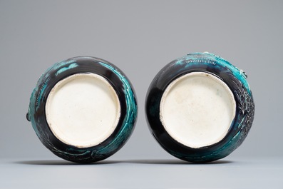 A pair of Chinese aubergine-ground Fahua jars with applied design, Kangxi