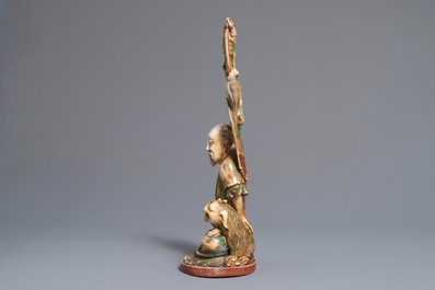 A large polychrome Chinese ivory group of a sage with a mythical beast, 19th C.