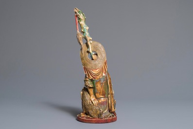 A large polychrome Chinese ivory group of a sage with a mythical beast, 19th C.