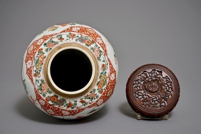 A Chinese famille verte vase with a carved wooden cover, Kangxi
