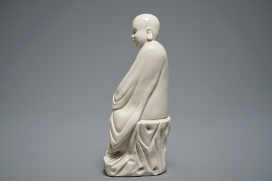 A Chinese Dehua blanc de Chine figure of a Luohan, 19th C.