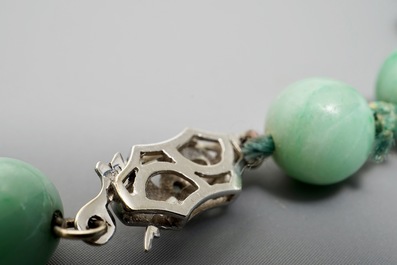 Two Chinese green jade beads necklaces, one with silver lock, 19/20th C.