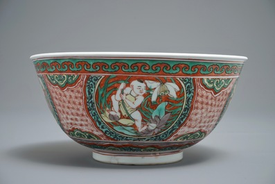 A Chinese wucai bowl with boys holding lotus flowers, Transitional period