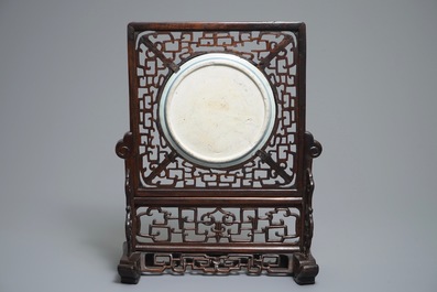 A Chinese carved wood table screen with a blue and white dragon medallion, Ming and 19th C.