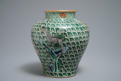 A Chinese famille verte vase with mythical beasts on a ground of waves, 19th C.