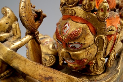 A Sino-Tibetan gilt bronze figure of Mahakala and his consort Yab-Yum, 19/20th C.