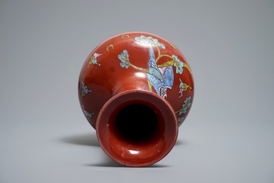 A Chinese oxblood-glazed bottle vase with an overglaze design of a qilin and a bird, 19th C.