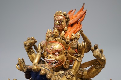 A Sino-Tibetan gilt bronze figure of Mahakala and his consort Yab-Yum, 19/20th C.