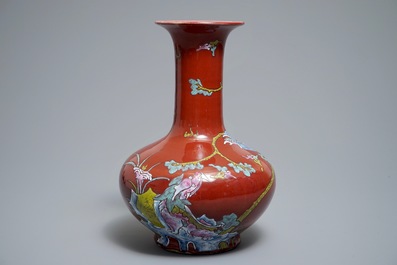 A Chinese oxblood-glazed bottle vase with an overglaze design of a qilin and a bird, 19th C.