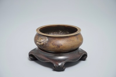 A Chinese bronze censer on wooden stand, Xuande mark, 18th C.