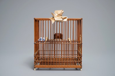 A Chinese wooden bird cage with ivory and porcelain ornaments, 19/20th C.