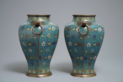 A pair of Chinese cloisonn&eacute; vases with floral design and ring handles, 19th C.