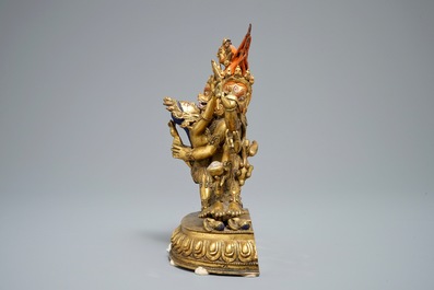 A Sino-Tibetan gilt bronze figure of Mahakala and his consort Yab-Yum, 19/20th C.