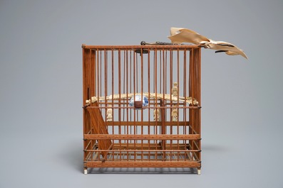 A Chinese wooden bird cage with ivory and porcelain ornaments, 19/20th C.