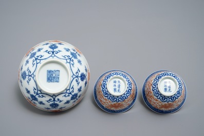 A pair of Chinese iron red and blue cups and a bowl, Qianlong and Guangxu marks, 19/20th C.