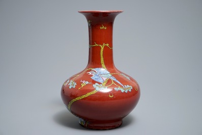 A Chinese oxblood-glazed bottle vase with an overglaze design of a qilin and a bird, 19th C.