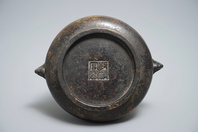 A Chinese bronze incense burner with elephant head handles, qianqing gongbao mark, Ming
