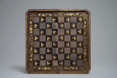 A Chinese lacquered chess and backgammon board with ivory chessmen, 19th C.