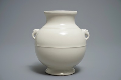 A Chinese cream-glazed hu vase with elephant handles, 18/19th C.