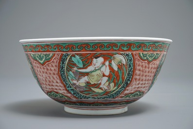 A Chinese wucai bowl with boys holding lotus flowers, Transitional period